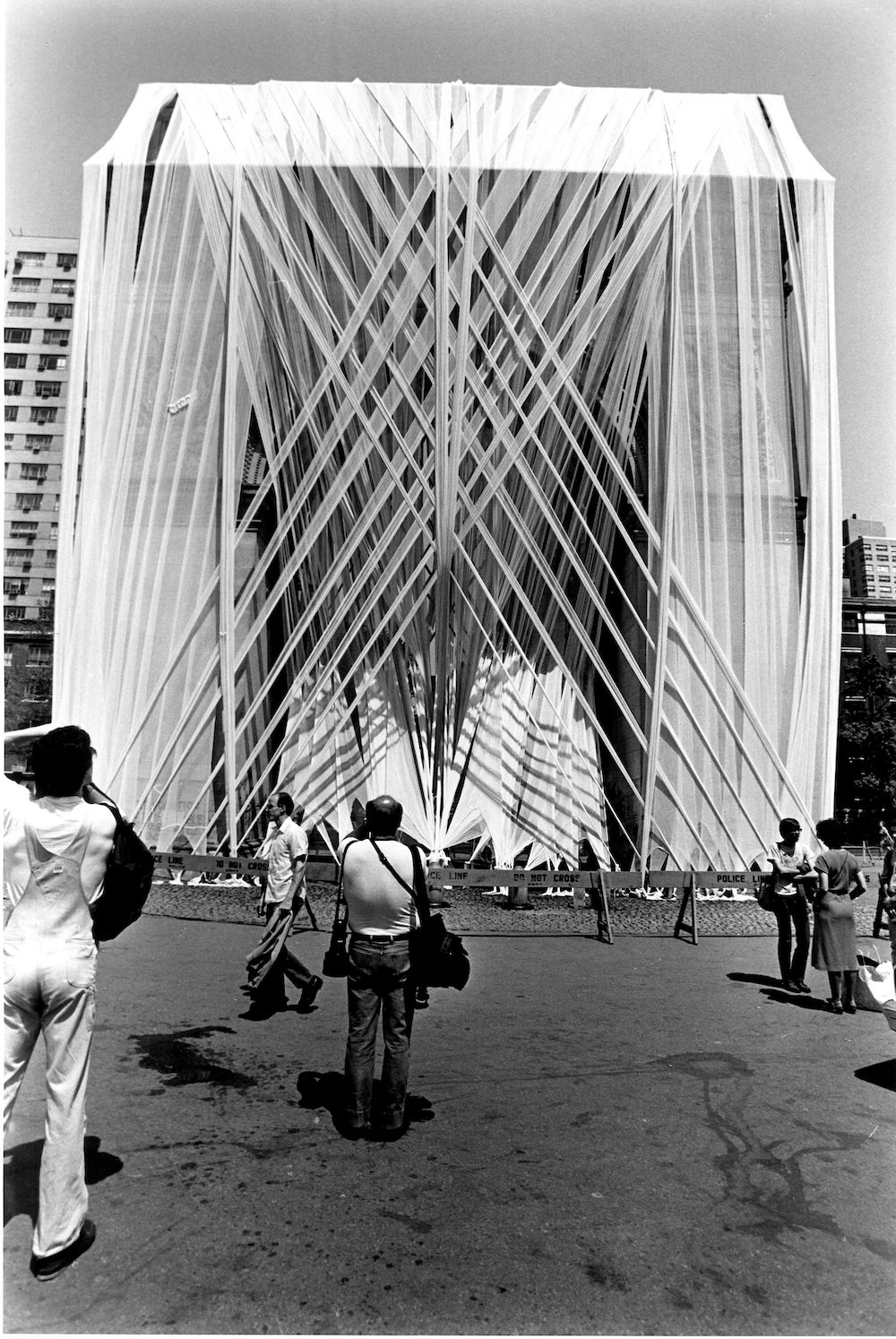 Francis Hines, Washington Square Arch Wrap, 1980, Washington Square Park, Manhattan, NYC Parks Photo Archive. In 1980 Francis Hines bound the iconic Washington Square Arch in strips of fabric, described as a giant bandage for a wounded monument. Sponsored by NYC, the installation was used to raise funds to restore the monument and park.<br/>